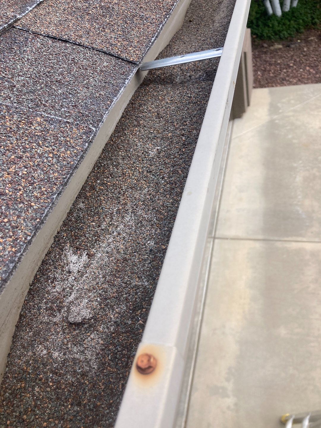 Gutter cleaning in Prescott valley with excessive debris from deteriorating roof shingles. Even treeless lots, gutters need cleaning. Thumbnail